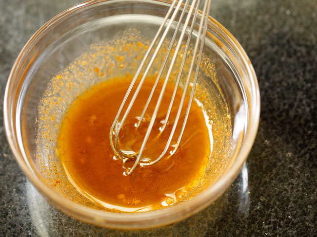 whisking the avocado salad dressing mixture.