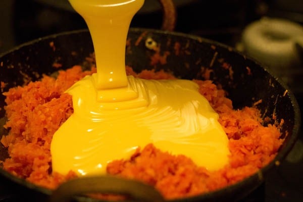 condensed milk being poured on carrots