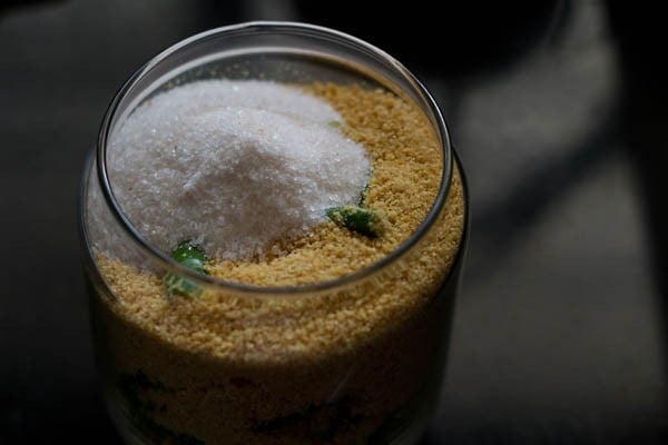 chopped green chillies (mirch), mustard seeds and salt in glass jar.