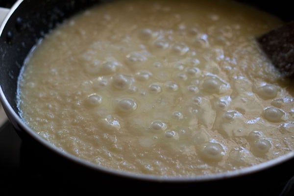 stirring the milk mixture with the fried moong lentils. 