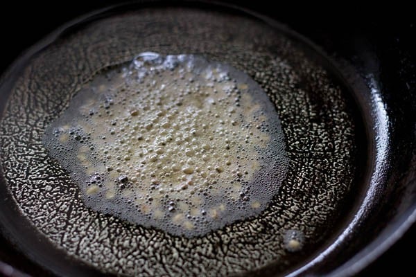 urad dal added to hot sunflower oil in pan. 