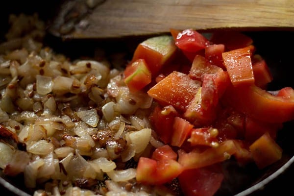 chopped tomatoes, asafoetida and salt added to the onions. 