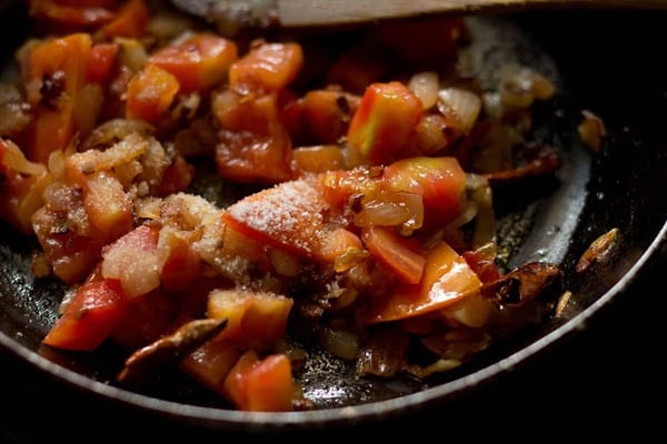 sautéing the tomatoes. 