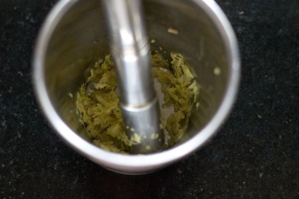 ginger garlic paste in a silver mortar and pestle for paneer makhani recipe