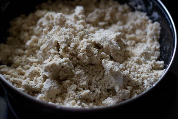 whole wheat flour, all purpose flour, carom seeds, cumin seeds and salt mixed with ghee to get a breadcrumb textured mixture for making dough for papdi recipe. 