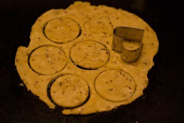 cutting out shapes using cookie cutters for papdi recipe. 