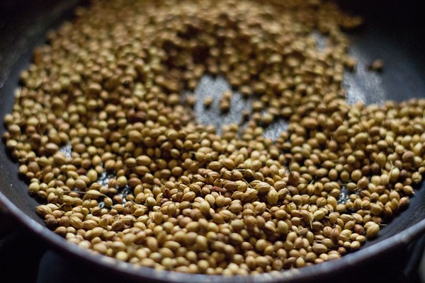 roasting coriander seeds, cumin seeds and fenugreek seeds in a pan. 