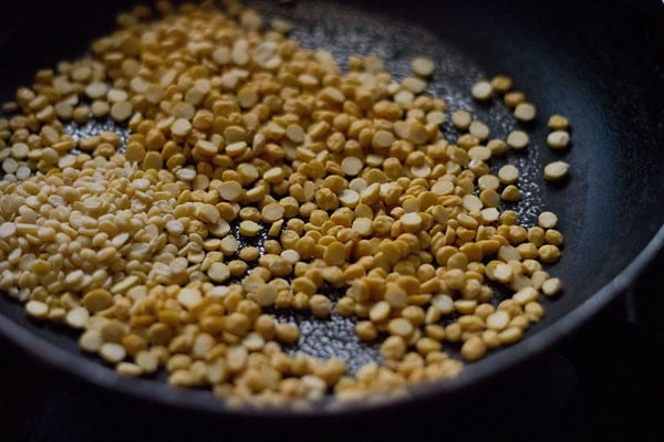 chana dal and urad dal added to the pan. 