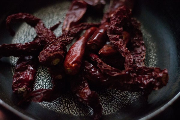 roasting dried red chilies in the same pan. 