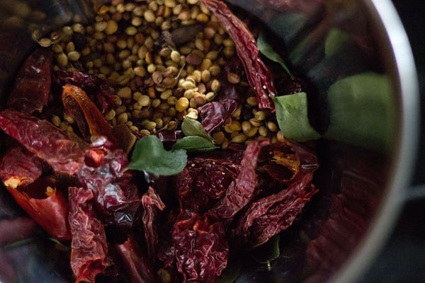 cooled roasted ingredients added to a grinder jar. 