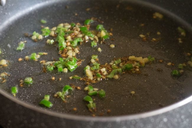 sauteing green chili and ginger