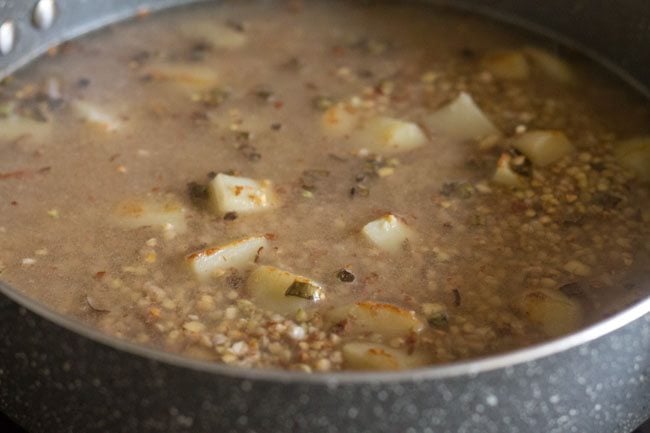 mixing sugar and salt with buckwheat khichdi