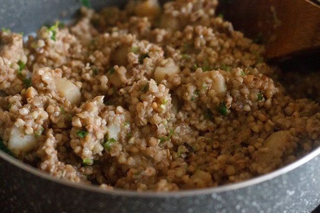 mixing coriander leaves with buckwheat khichdi