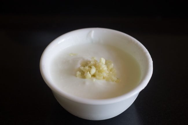 finely minced garlic added to whisked curd.