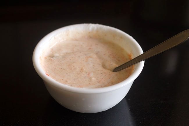 spice powders and salt mixed well in the whisked curd.