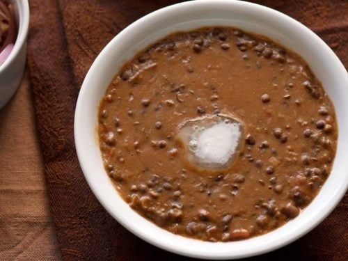 dal bukhara with butter melted in center in white bowl