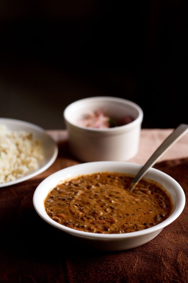 dal bukhara served in white bowl with a spoon inside the bowl