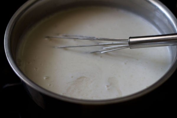 agar agar solution added to milky panna cotta base.
