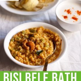 bisi bele bath served in a white bowl with a spoon in it and a bowl of banana chips and small bowl of raita kept in top left and right side and text layovers.