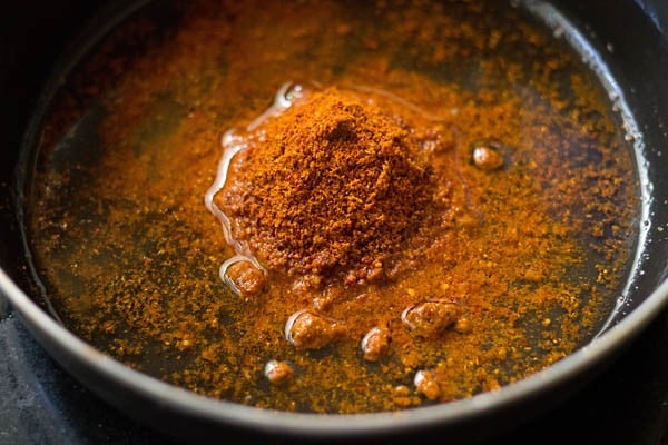 bisi bele bath masala and water added in a pan. 