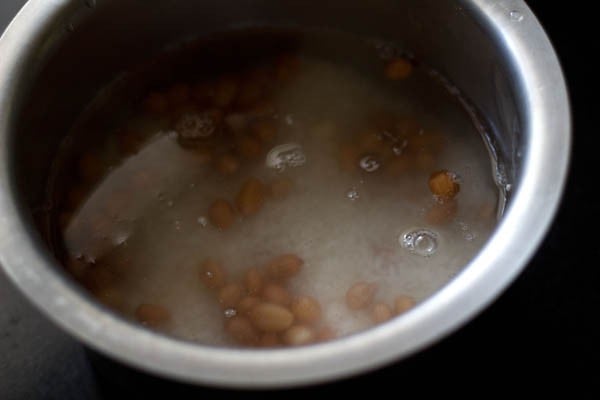 soaking rice and peanuts in water for bisi bele bath recipe. 