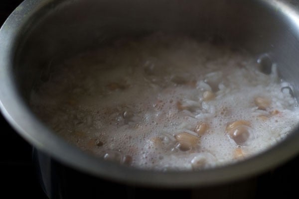 cooking rice with peanuts for bisi bele bath recipe. 