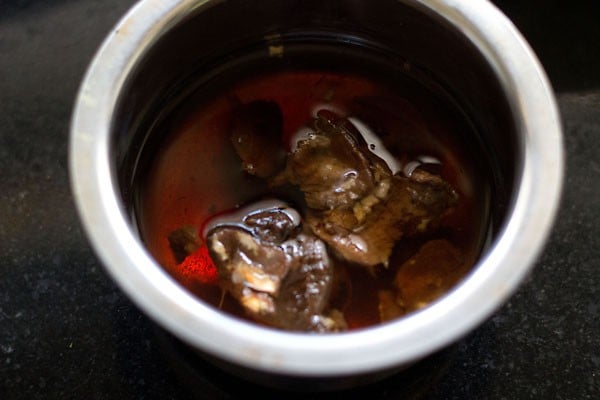 soaking tightly packed tamarind in water for bisi bele bath recipe. 