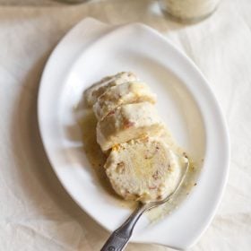 sliced kulfi with a spoon on a white plate