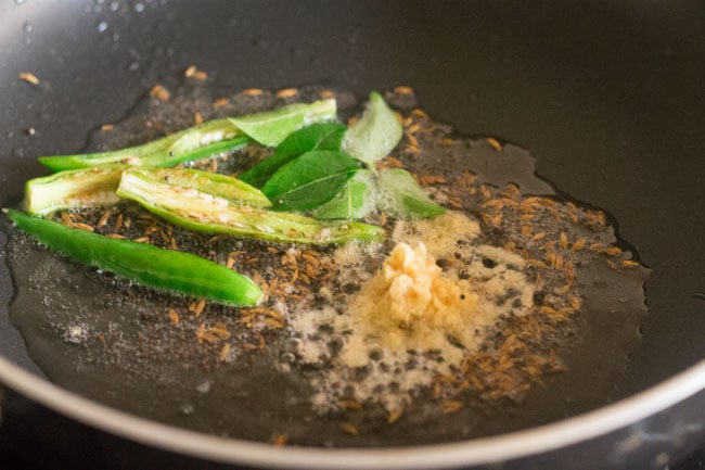 slit green chilies, minced ginger and curry leaves added to the pan. 