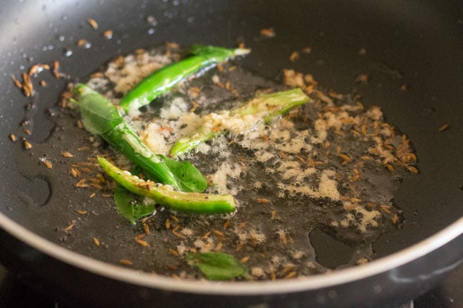 sautéing ingredients in the pan.