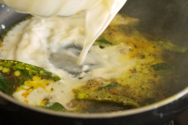 Add the prepared kadhi mixture to the pan. 