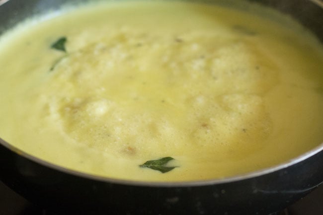 The kadhi is boiled and thickened. 