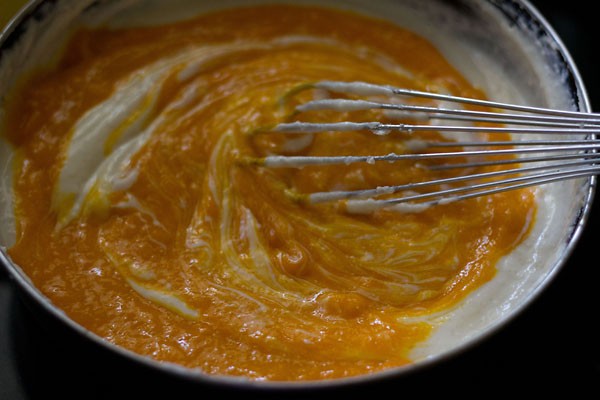 adding mango purée to cream cheese mixture.