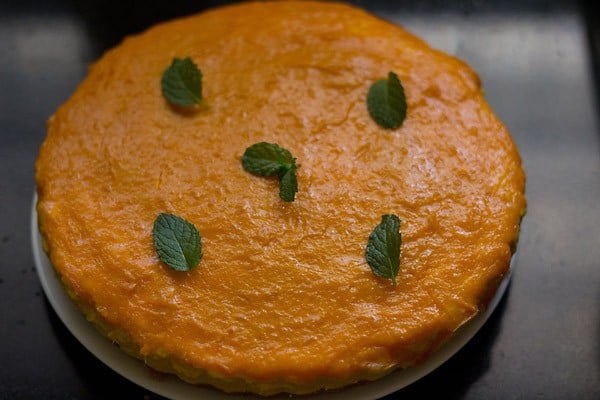 mango cheese cake after refrigeration, topped with some fresh mint.