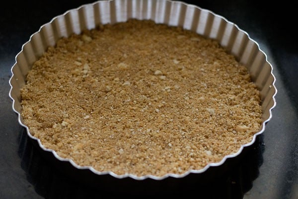 crust has been pressed into the tin in an even layer.