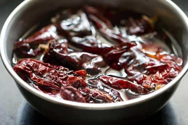 red chillies soaking in water in a bowl.