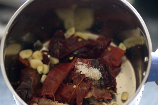 garlic, soaked red chillies and salt in a blender.