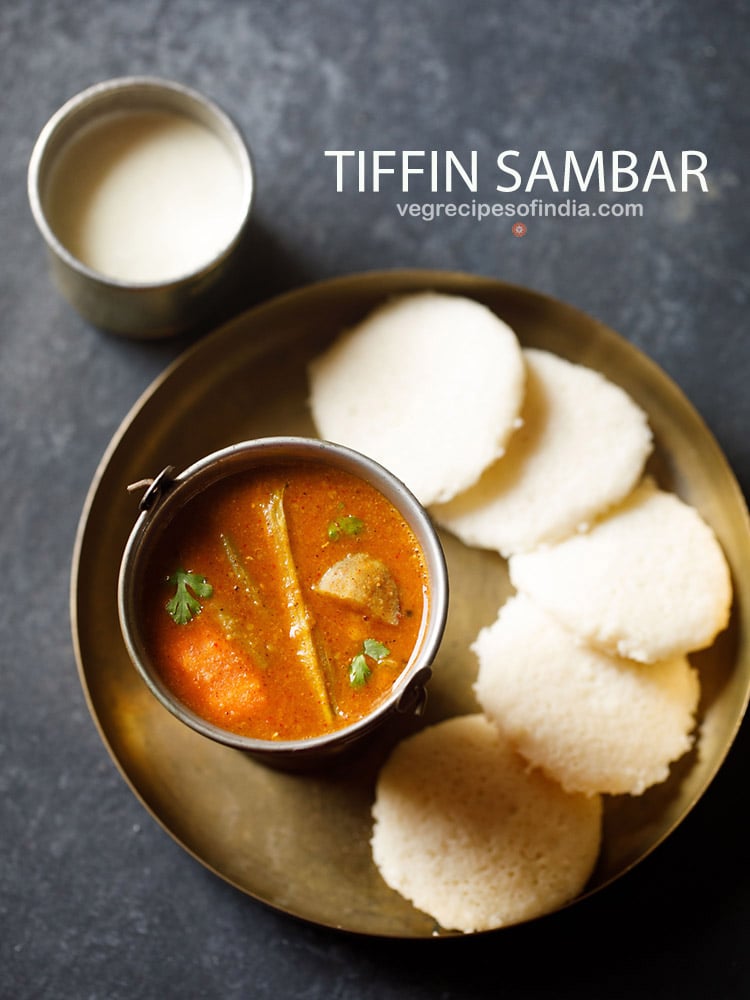 idlis in a plate served with sambar in a bowl