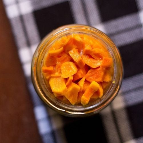 turmeric pickle in a jar on a checkered napkin