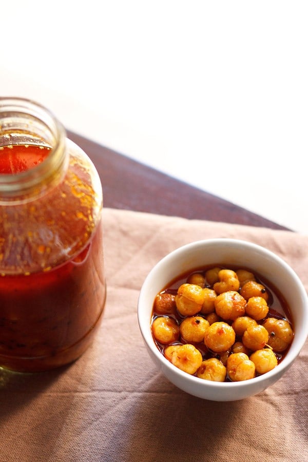 star gooseberry pickle served in a bowl with a pickle jar on the side. 