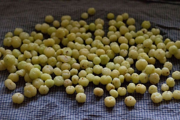 rinsing star gooseberries and drying them on a kitchen towel.