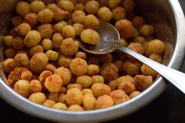 mixing spices with the star gooseberries. 