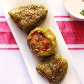 stuffed capsicum served on a long white platter.