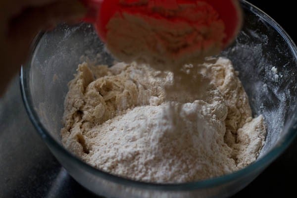 last batch of whole wheat flour added to the mixture and begun kneading with hands for making pizza pockets. 