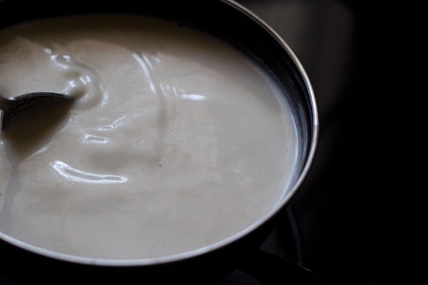 cooking the eggless custard mixture to make bread and butter pudding.