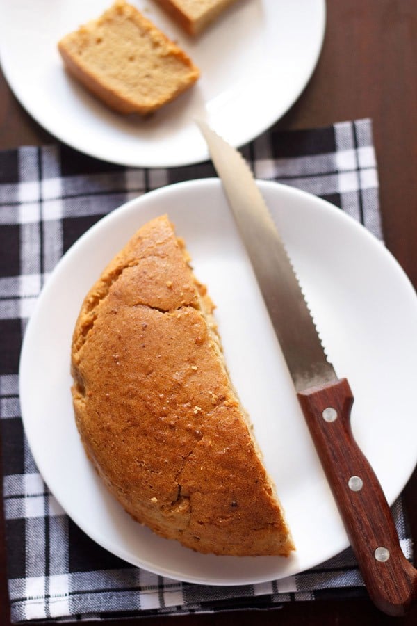 eggless mawa cake served on a white plate with a knife