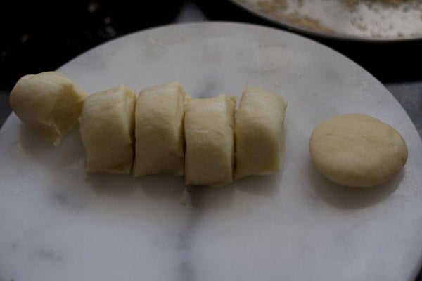 take one karanhi dough part in peda shape