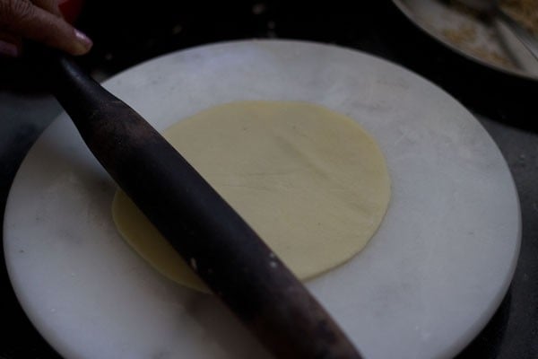 roll the dough round in 4 to 5 inches diameter circle.