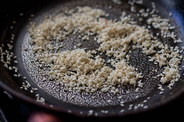 roasting sesame seeds in a pan