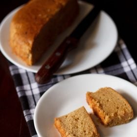 eggless mawa cake slices served on a white plate.